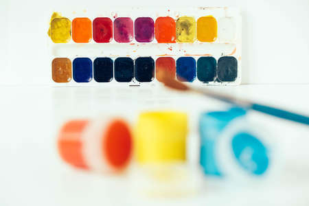 Set of watercolor paints and brushes for painting on a white background. Top view. Copy, empty space for text.の写真素材