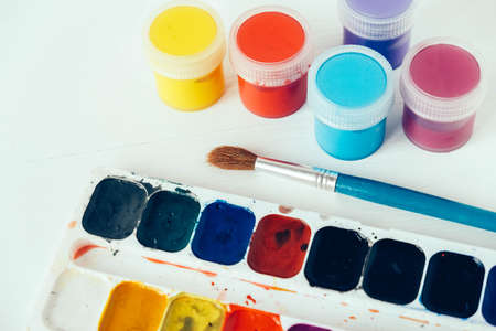 Set of watercolor paints and brushes for painting on a white background. Top view. Copy, empty space for text.の写真素材