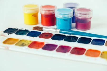 Set of watercolor paints and brushes for painting on a white background. Top view. Copy, empty space for text.の写真素材