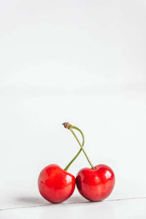 Fresh ripe cherries on the white wooden background. Copy, empty space for text.の写真素材