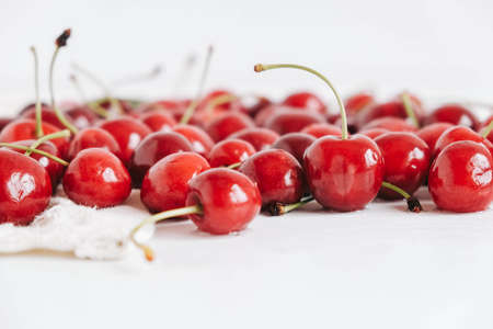 Fresh ripe cherry on the white wooden background. Top view. Copy, empty space for text.の写真素材