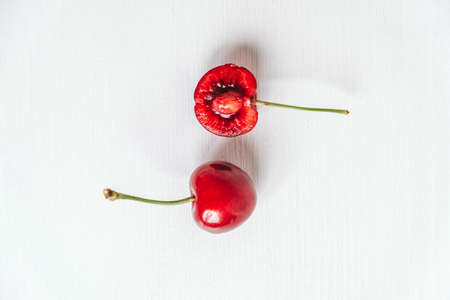 Fresh ripe cherries on the white wooden background. Top view. Copy, empty space for text.の写真素材