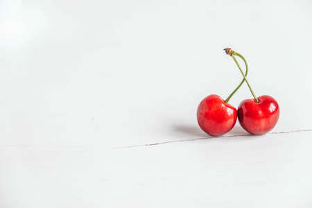 Fresh ripe cherries on the white wooden background. Copy, empty space for text.の写真素材