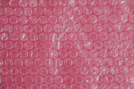Packaging with air bubbles on a pink background.  texture, packaging, air bubble film. Top view. Copy, empty space for text.の写真素材