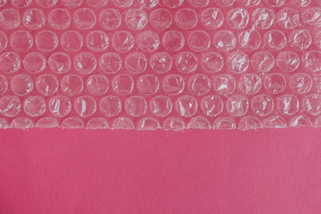 Packaging with air bubbles on a pink background.
