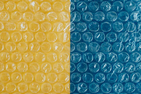 Packaging with air bubbles on a yellow and blue background.の写真素材