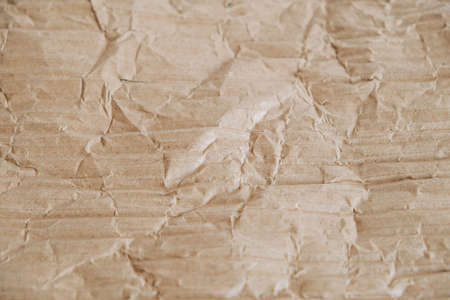 Crumpled corrugated cardboard surface texture background. Seamless crumpled brown paper textured backdrop. Top view. Copy, empty space for text.の写真素材