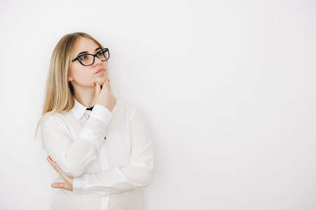 Portrait of a beautiful blonde girl with natural beauty in a green leaves trees. Copy, empty space for text.の写真素材