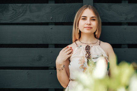 Portrait of a beautiful blonde girl with natural beauty in a green leaves trees. Copy, empty space for text.の写真素材