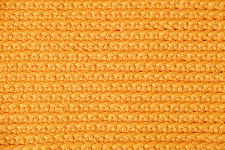 Orange knitted fabric texture background. Top view. Copy, empty space for text.の写真素材