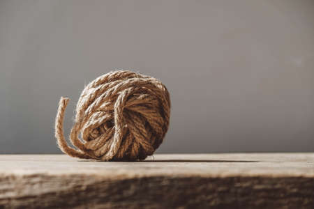 Brown ball of rope on old wooden background. Copy, empty space for text.の写真素材