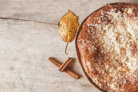 Homemade apple pie and cinnamon on vintage wooden background texture. Top view. Copy, empty space for text.の写真素材