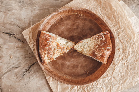 Piece of homemade apple pie in a paper plate on a wooden background. Top view. Copy, empty space for text.の写真素材