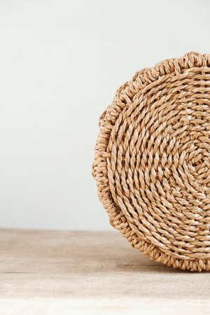 Details of a round wicker basket on an old wooden background. Copy, empty space for text.の写真素材