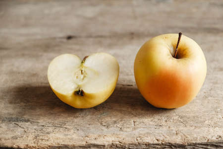 Two yellow apples on an old wooden background. Top view. Copy, empty space for text.の写真素材