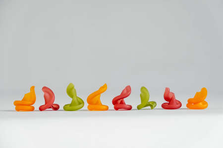 Multicolored pasta lie in line on a white background. Copy, empty space for text.の写真素材