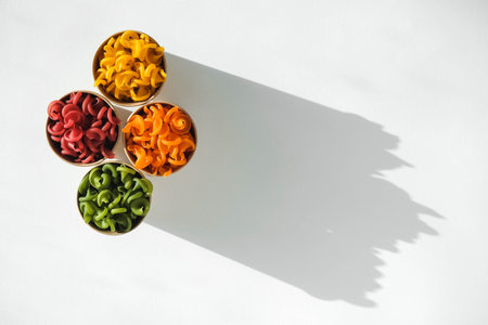 Multicolored pasta in a disposable kraft paper cups scattered on a white background. Top view. Copy, empty space for text.の写真素材
