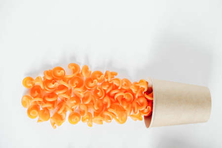 Orangepasta in a disposable kraft paper cup on a white background. Top view. Copy, empty space for text.の写真素材