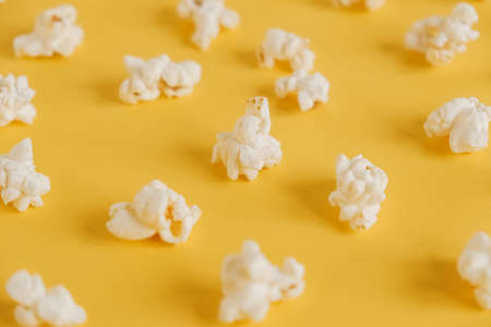 Popcorn on a yellow background as a background image. Top view. Copy, empty space for text.の写真素材