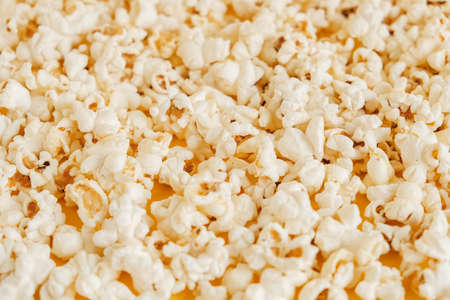 Popcorn on a yellow background as a background image. Top view. Copy, empty space for text.の写真素材