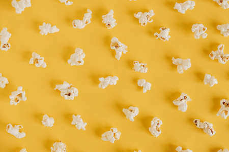 Popcorn on a yellow background as a background image. Top view. Copy, empty space for text.の写真素材