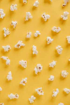 Popcorn on a yellow background as a background image. Top view. Copy, empty space for text.の写真素材
