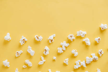 Popcorn on a yellow background as a background image. Top view. Copy, empty space for text.の写真素材