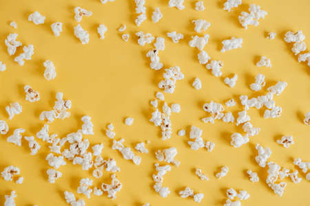 Popcorn on a yellow background as a background image. Top view. Copy, empty space for text.の写真素材