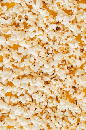 Popcorn on a yellow background as a background image. Top view. Copy, empty space for text.の写真素材