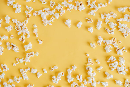 Popcorn on a yellow background as a background image. Top view. Copy, empty space for text.の写真素材