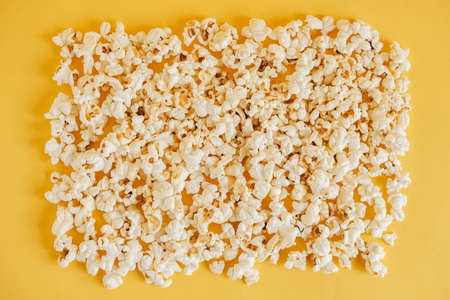 Popcorn on a yellow background as a background image. Top view. Copy, empty space for text.の写真素材