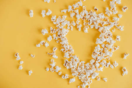 Popcorn on a yellow background as a background image. Top view. Copy, empty space for text.の写真素材