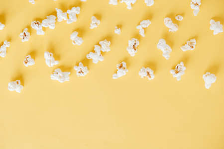 Popcorn on a yellow background as a background image. Top view. Copy, empty space for text.の写真素材