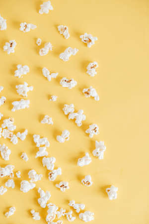 Popcorn on a yellow background as a background image. Top view. Copy, empty space for text.の写真素材