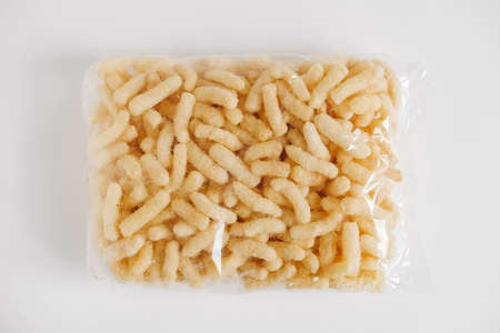 Corn sticks in a plastic bag on a white background. Top view. Copy, empty space for text.の写真素材