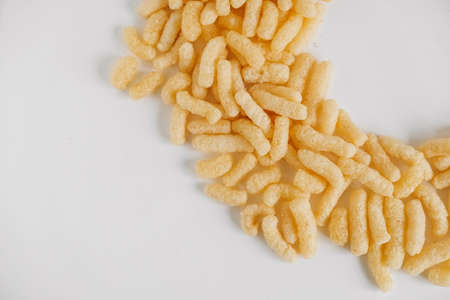 Corn sticks on a white background. Top view. Place for your text.の写真素材