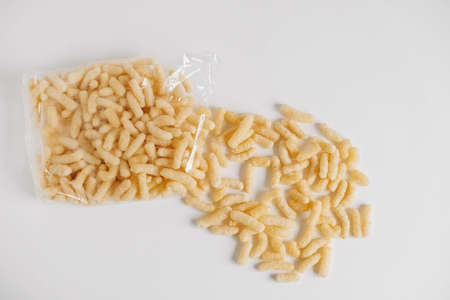 Corn sticks in a plastic bag on a white background. Top view. Copy, empty space for text.の写真素材