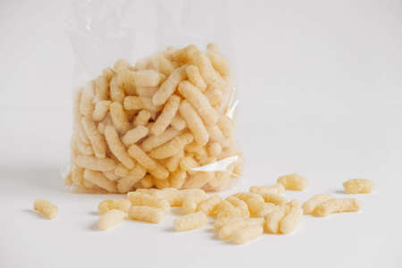 Corn sticks in a plastic bag on a white background. Place for your text.の写真素材
