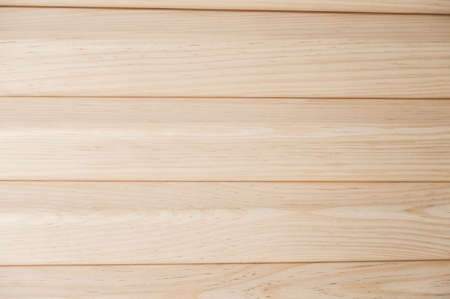 Joiner's boards from light natural wood are stacked on each other. Timber harvesting. Details of a lumber bar close-up. Hobbies of needlework, woodworking.の写真素材