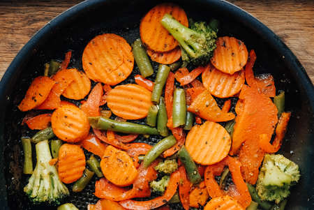 Mixed vegetables are fried in a pan. Top view. Copy, empty space for text.の写真素材