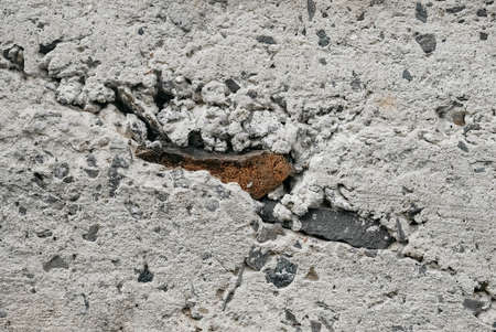 Gray old concrete surface with cracks and stones as a background texture ..の写真素材