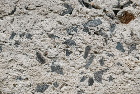 Gray old concrete surface with cracks and stones as a background texture ..の写真素材