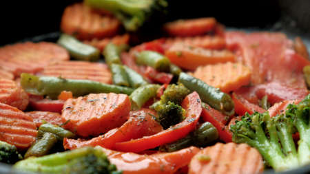 Mixed vegetables that are fried and cooked in a pan.の写真素材