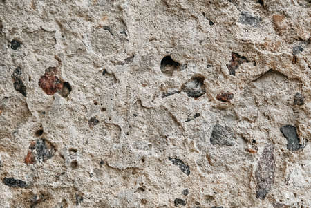 Gray old concrete surface with cracks and stones as a background texture. Copy, empty space for text.の写真素材
