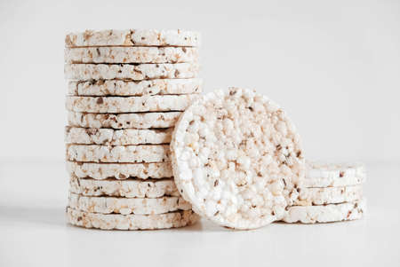 Round diet crispbreads on a white background. Round shaped cereal bread, healthy food without yeast. Copy, empty space for text.の写真素材