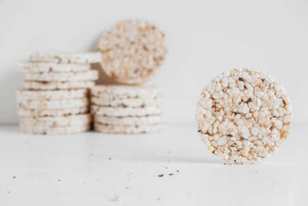 Round diet crispbreads on a white background. Round shaped cereal bread, healthy food without yeast. Copy, empty space for text.の写真素材