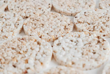 Round diet crispbreads on a white background. Round shaped cereal bread, healthy food without yeast. Top view. Copy, empty space for text.の写真素材