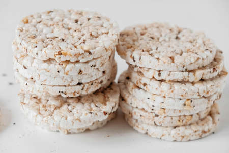 Round diet crispbreads on a white background. Round shaped cereal bread, healthy food without yeast. Copy, empty space for text.の写真素材