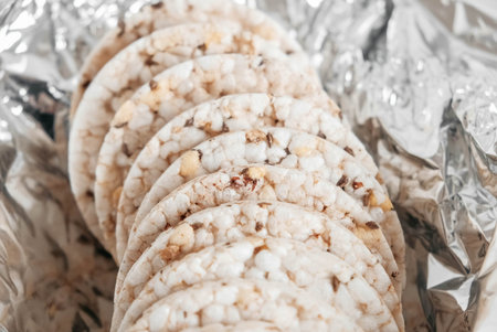 Round diet crispbreads on a background of silver packaging. Round shaped cereal bread, healthy food...