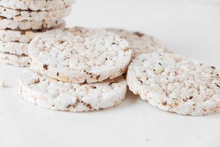 Round diet crispbreads on a white background. Round shaped cereal bread, healthy food without yeast. Copy, empty space for text.の写真素材